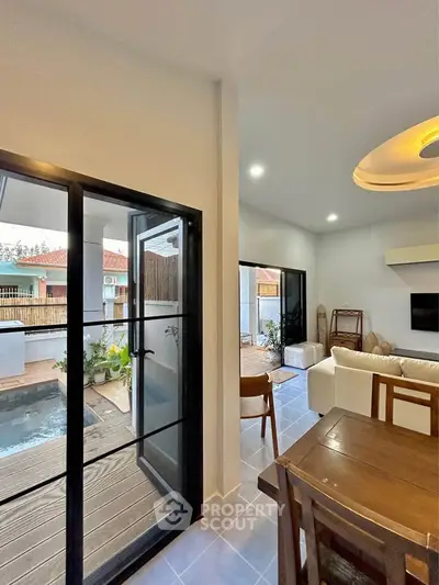 Modern living room with pool view and stylish interior design