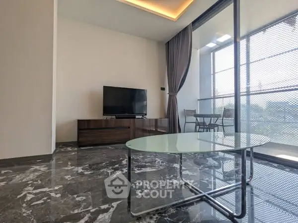 Modern living room with marble flooring and large glass windows