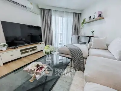 Modern living room with cozy sectional sofa and large TV, perfect for relaxation.