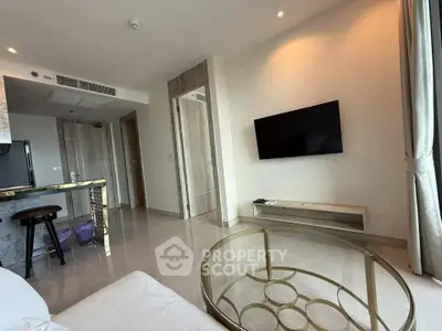 Modern living room with wall-mounted TV and stylish glass coffee table