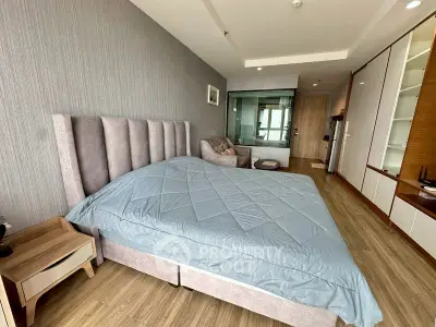 Spacious bedroom with modern decor and large bed in stylish apartment.