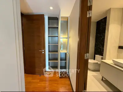Modern bathroom with wooden flooring and sleek storage solutions