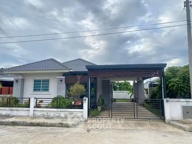 Charming single-story house with modern design and spacious driveway in a serene neighborhood.