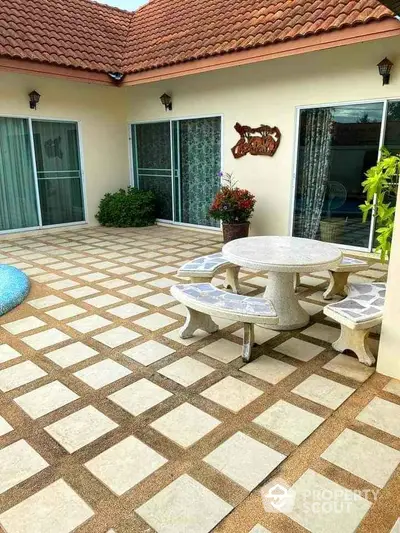 Charming patio with elegant tile design and cozy outdoor seating area