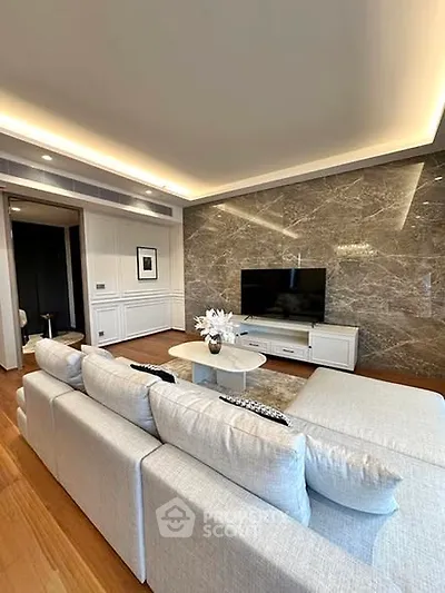 Luxurious living room with elegant marble accent wall and modern furniture
