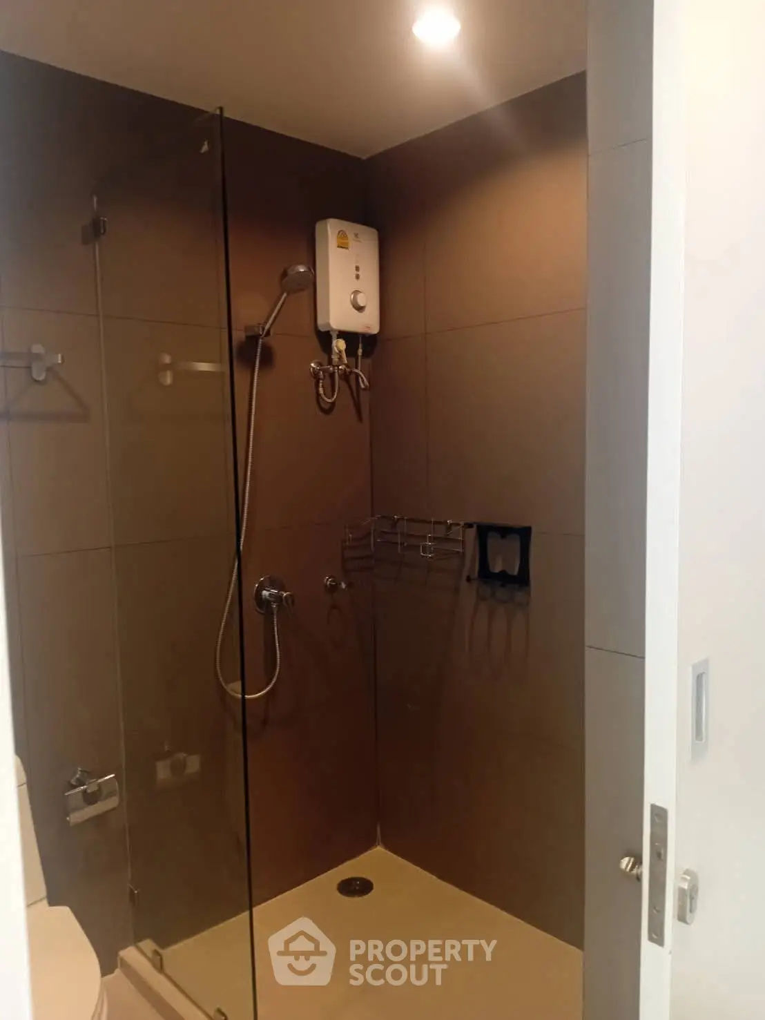 Modern bathroom with glass shower enclosure and water heater