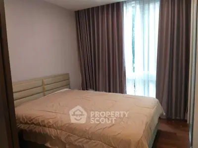 Cozy bedroom with elegant curtains and soft lighting, perfect for relaxation.