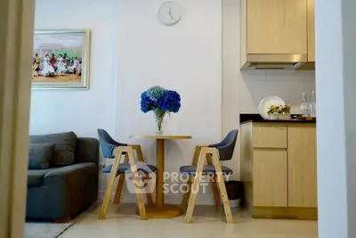 Charming modern living area with cozy seating and stylish kitchen corner, perfect for urban living.