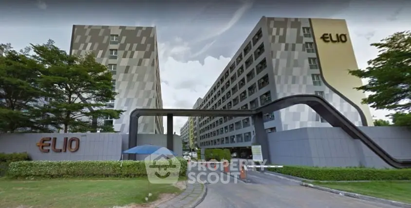 Modern residential building with unique facade and lush greenery entrance