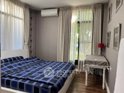 Spacious and well-lit bedroom with large windows, elegant curtains, and a comfortable king-size bed, perfect for restful nights in a serene setting.