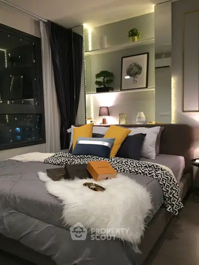 Luxurious bedroom with modern decor and ambient lighting, featuring plush bedding and stylish accents.
