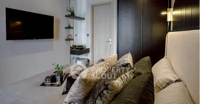 Luxurious bedroom with plush pillows and modern decor, featuring a wall-mounted TV and sleek shelving.