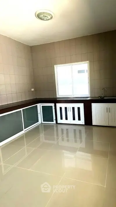 Spacious kitchen with closed layout and ample storage space