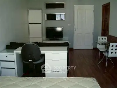 Modern studio apartment with sleek furniture and hardwood floors