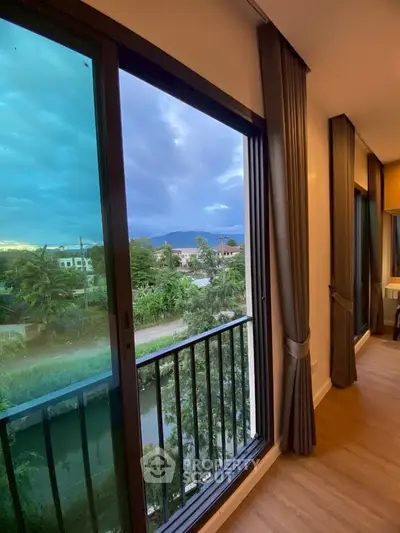 Stunning balcony view with lush greenery and mountain backdrop, perfect for serene living.