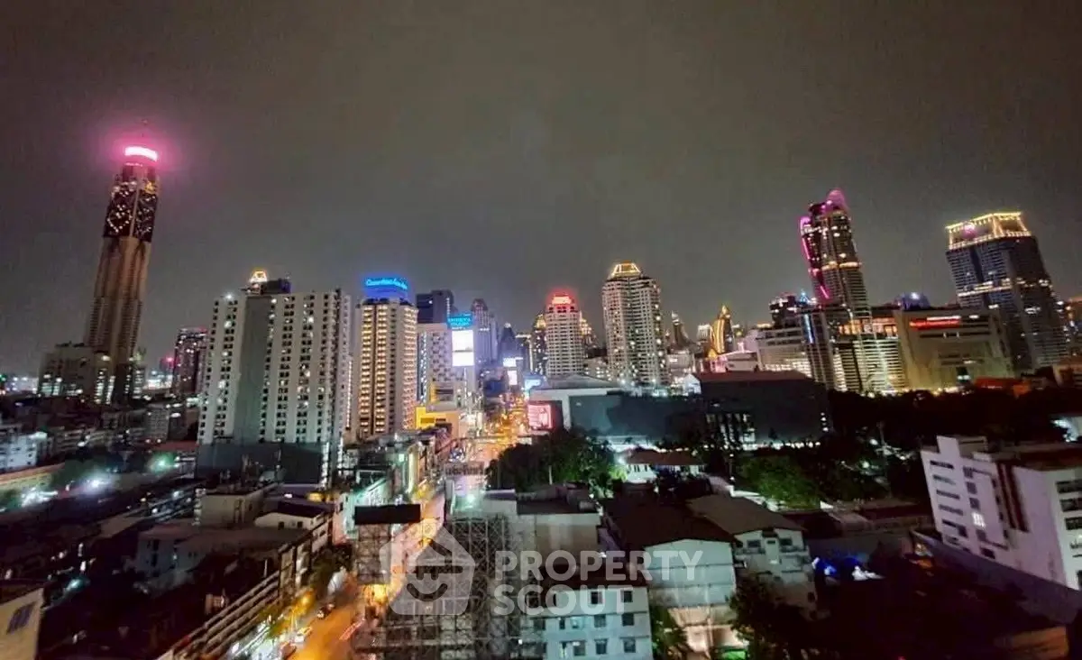 Stunning nighttime cityscape view showcasing vibrant urban skyline with illuminated skyscrapers.