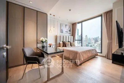 Luxurious bedroom with city view, modern furnishings, and elegant decor in high-rise apartment.
