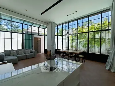 Spacious modern living room with large windows and elegant decor
