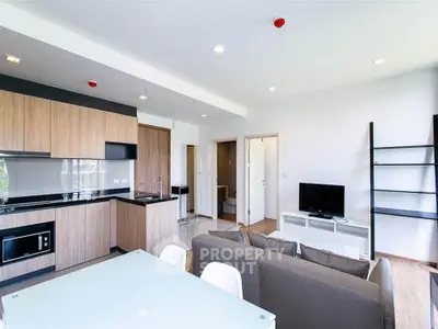 Modern open-plan living room with sleek kitchen and stylish furniture
