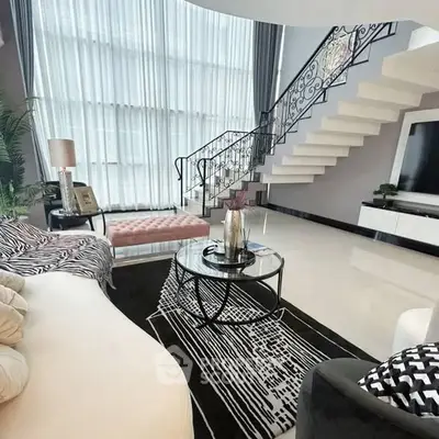 Luxurious living room with elegant staircase and modern decor