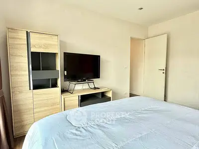 Modern bedroom with sleek TV and stylish wooden furniture