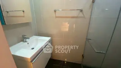 Modern bathroom with sleek sink and glass shower enclosure