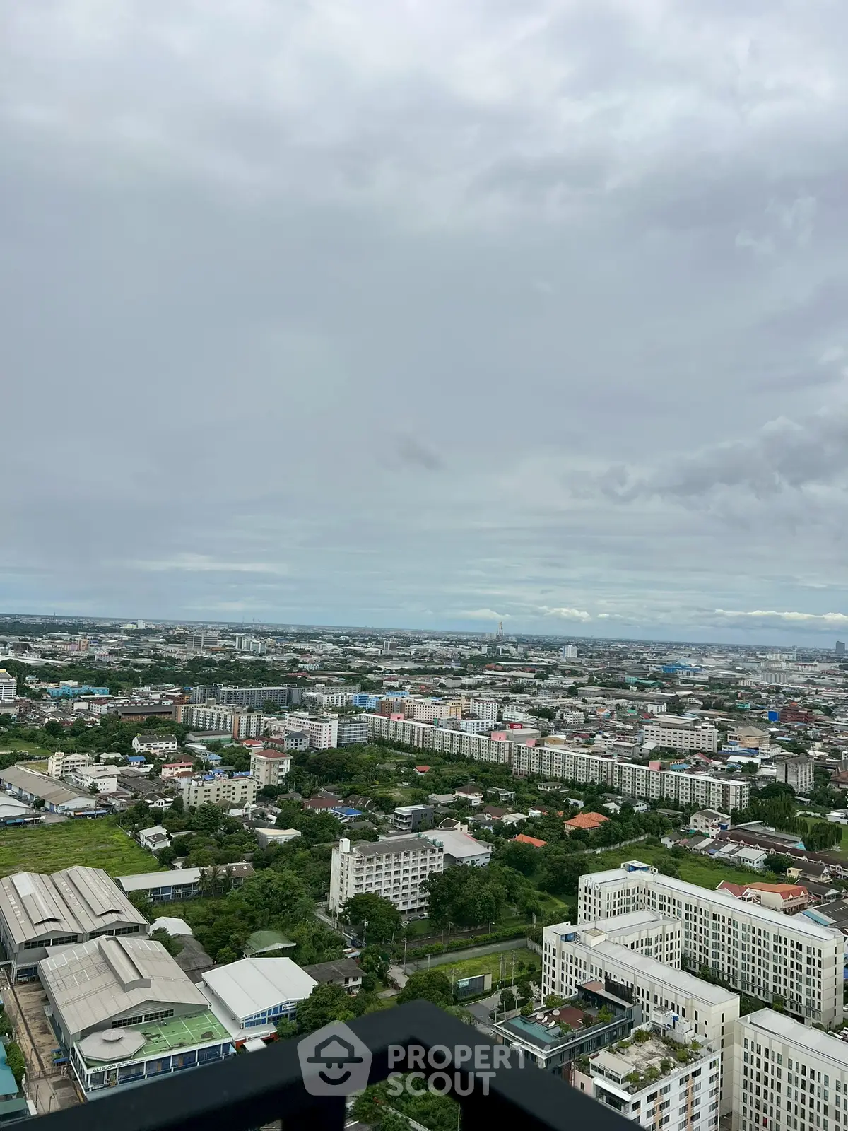Stunning cityscape view from high-rise balcony showcasing urban living and expansive skyline.