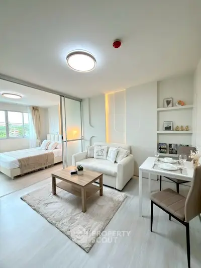 Modern open-plan living room with cozy bedroom and stylish decor