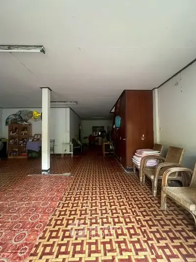 Spacious interior with unique patterned flooring and ample seating, ideal for versatile living arrangements.