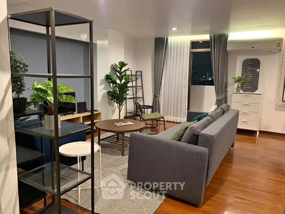 Stylish modern living room with city view, featuring sleek furniture and elegant decor.