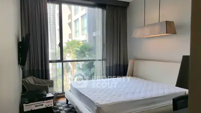 Modern bedroom with large window and stylish lighting in urban apartment