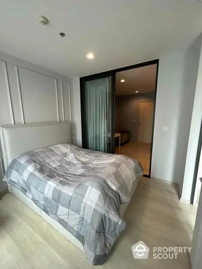 Modern bedroom with stylish decor and cozy ambiance in a contemporary apartment.