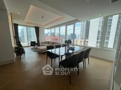 Spacious modern living room with city view and elegant dining area