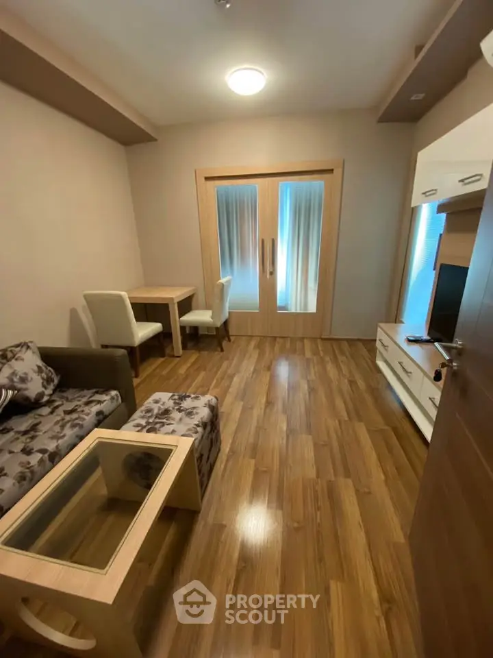 Cozy living room with wooden flooring and modern furniture in a stylish apartment.