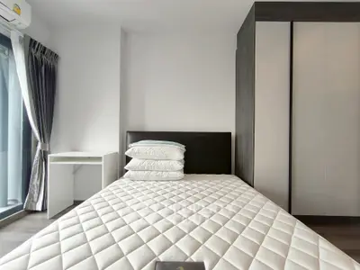 Modern bedroom with stylish wardrobe and large window for natural light.