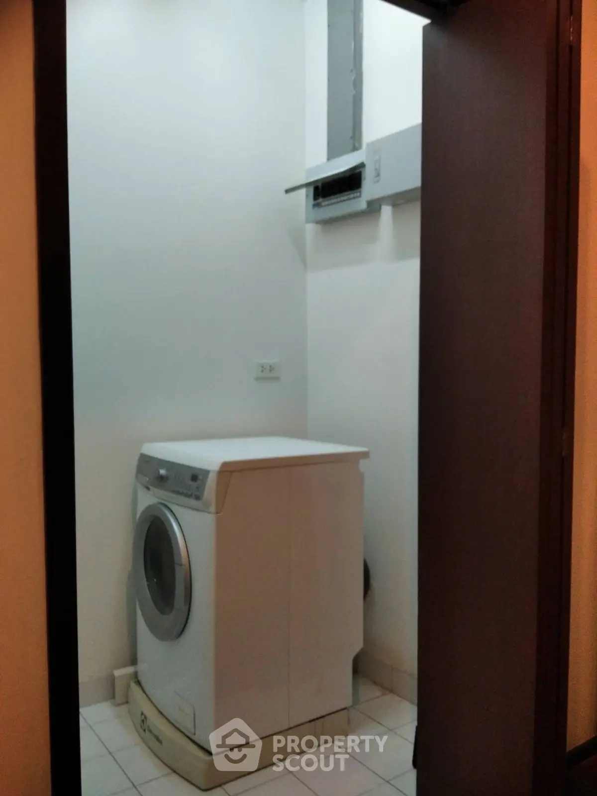 Compact laundry room with washing machine in modern apartment