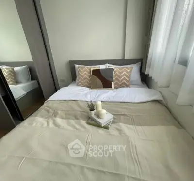 Cozy bedroom with stylish decor and ample natural light