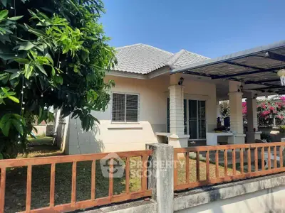 Charming single-story house with a spacious yard and covered patio, perfect for family living.