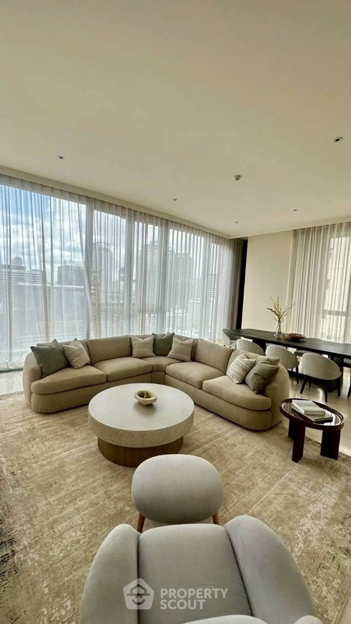 Luxurious living room with panoramic city views and elegant furnishings.