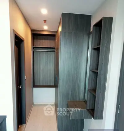 Modern walk-in closet with sleek wooden finishes and ample storage space.