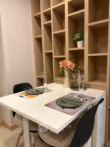 Chic dining area with modern table and stylish shelving, perfect for cozy meals and elegant decor.