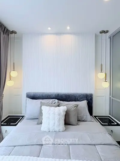 Modern bedroom with elegant lighting and plush bedding