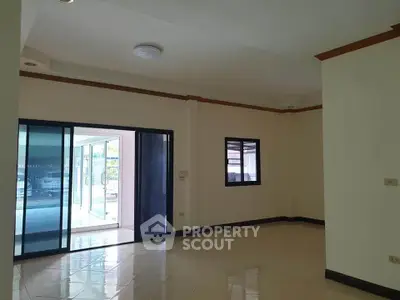 Spacious interior with sliding glass doors and tiled flooring, ideal for modern living.