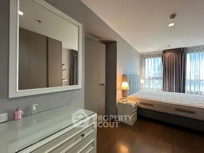 Spacious modern bedroom with elegant decor and ample natural light