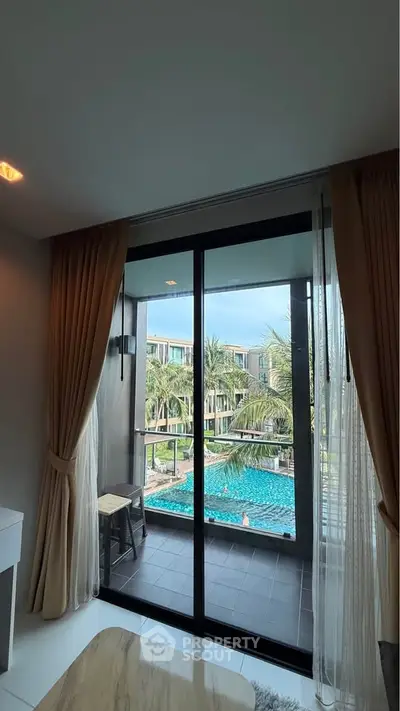 Luxurious apartment with pool view and elegant balcony, perfect for relaxation and leisure.