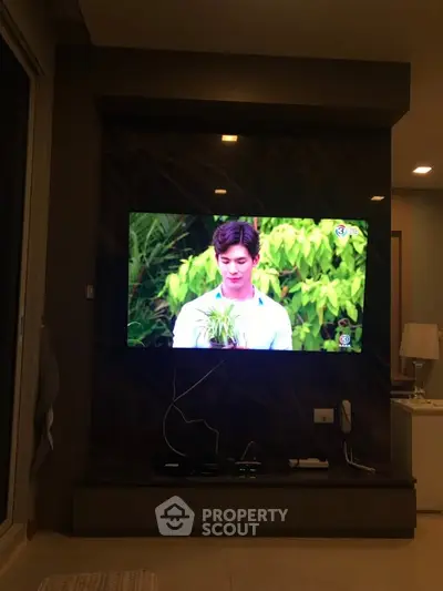 Modern living room with wall-mounted TV and stylish decor