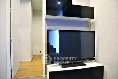 Modern living room with sleek black TV unit and stylish shelving