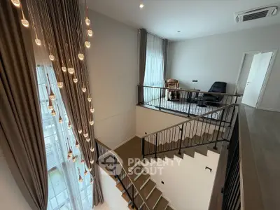 Elegant two-story living space with modern staircase and stylish lighting