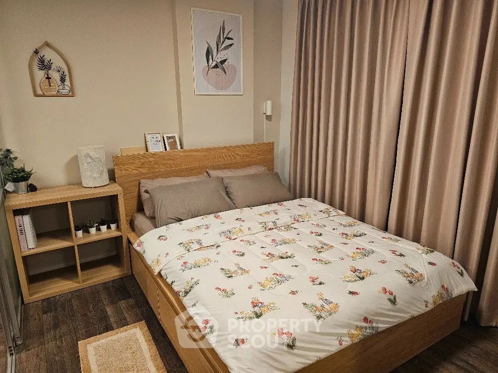 Cozy bedroom with floral bedding and wooden furniture, perfect for relaxation.