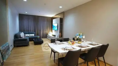 Modern living room with dining area, stylish decor, and cozy ambiance.